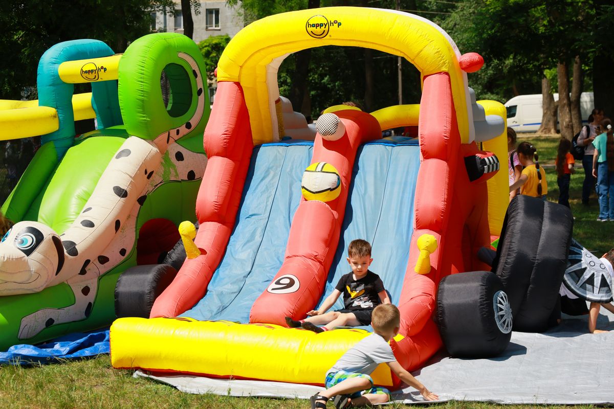 Children,Playing,On,Inflatable,Slide,At,Outdoor,Event.,May,31,